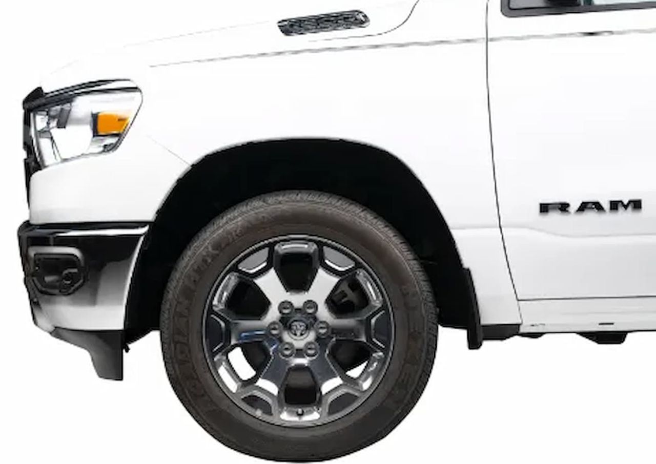 Front left side of a white RAM truck showing the tire, wheel, and part of the door.