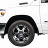 Front left side of a white RAM truck showing the tire, wheel, and part of the door.
